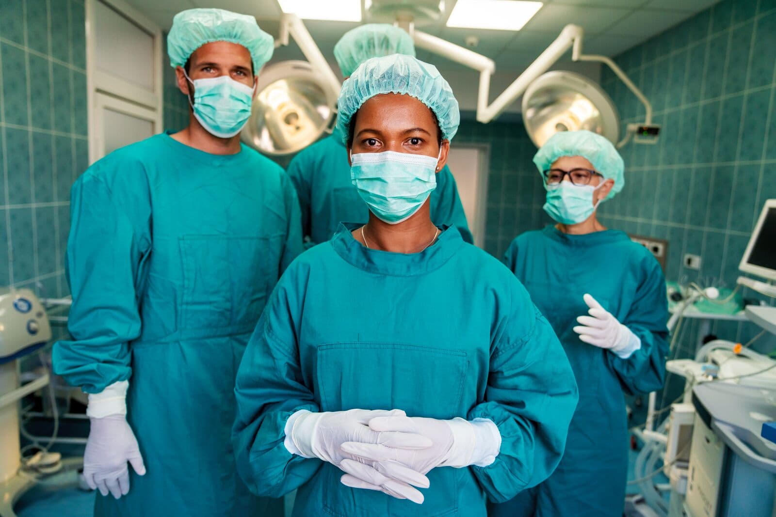 Surgical team standing in a brightly lit operating room
